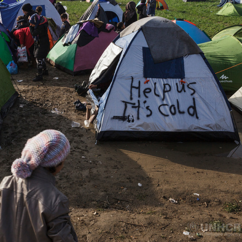 "Open the borders" and "Help us it's cold" written across tents in refugee camps as a cold winter with insufficient heating provision approaches