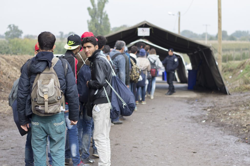 Sid, Serbia - October 17, 2015: Refugees waiting to cross the Serbo-Croatian border between the cities of Sid (Serbia) and Bapska (Croatia).